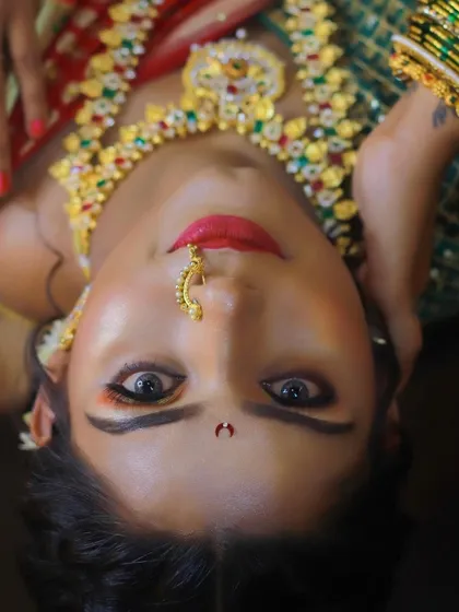 A creative shot of our Maharashtrian bridal demonstration look, highlighting the vibrant eye makeup and traditional gold jewelry.