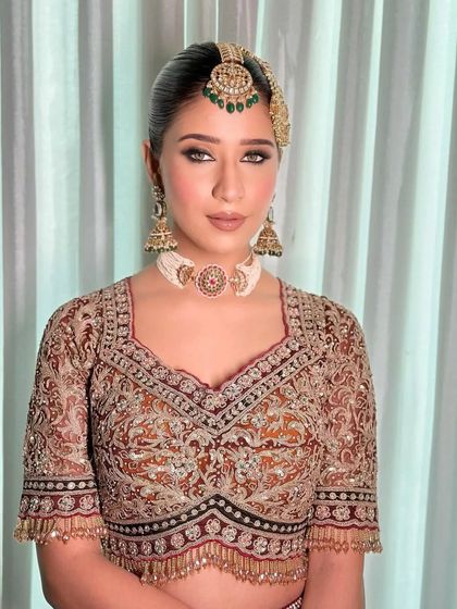 A front-facing view of the Marwar-inspired bride, showcasing her unique jewelry.
