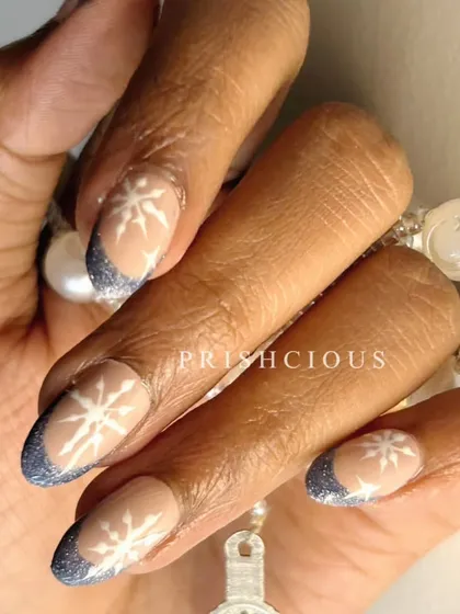 A different view of the snowflake French tip nails, showing how the glitter catches the light. This is such a pretty and elegant design for the winter season.