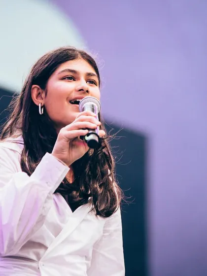 A close-up of one of our vocal students, singing her heart out at the Art Mumbai festival. We help our students channel their passion into powerful performances.