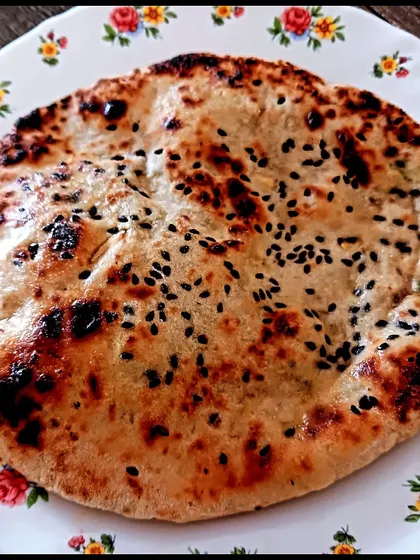 A perfectly soft and charred gluten-free naan, stuffed with spiced tofu and made from millet flour. This shows that dietary restrictions don't mean compromising on classic Indian breads.