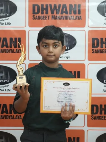 A young winner from our kids' drawing class with his first art trophy.