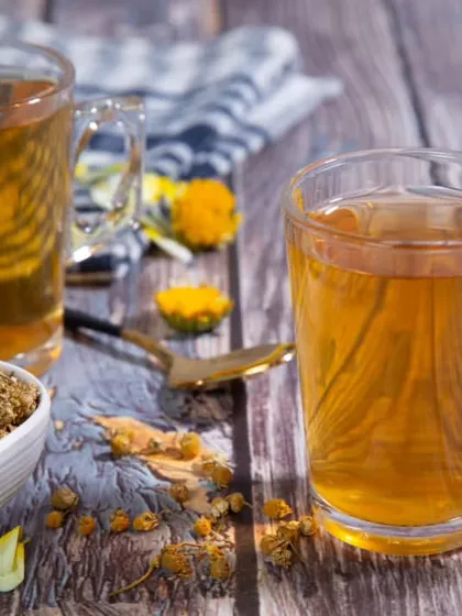 A product shot for a chamomile tea brand. I composed the image with two cups of tea and a bowl of dried chamomile flowers on a rustic wooden surface to evoke a sense of calm and natural wellness.