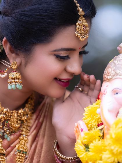 A close-up of our temple jhumkas with delicate green bead drops. These earrings are lightweight enough for long events but grand enough for a bridal look.
