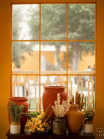 A beautifully styled window sill at the 'Kesar Sehar' Haldi, featuring terracotta pots and dried flowers. The design celebrated the rustic and artisanal heritage of India.