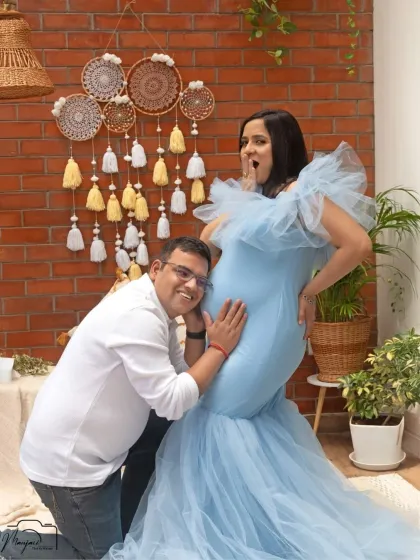 A playful and fun moment! The dad-to-be listens to the bump, and her surprised expression makes for a wonderfully candid and memorable photo.