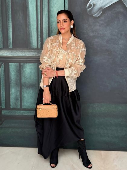 The full look for Isha's press event. The makeup is clean, powerful, and perfectly suited for a bossbabe.