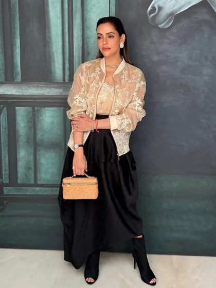 The full look for Isha's press event. The makeup is clean, powerful, and perfectly suited for a bossbabe.