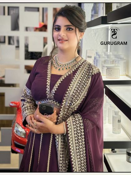 Getting this client ready for a wedding event. I created an elegant updo and a soft-glam makeup look that complemented her beautiful purple and silver outfit.