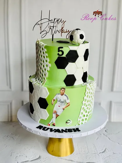 Made to order, baked to perfection. This two-tier football-themed cake is perfect for a sports fan's birthday celebration.