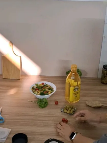 A behind-the-scenes look at styling a food shot, with our team arranging pasta and fresh ingredients around the product.