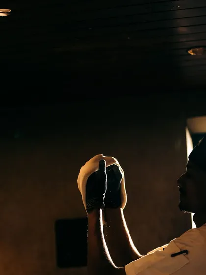 A silhouette of a chef tossing dough. The focus and skill required to perfect this craft is something we pride ourselves on.