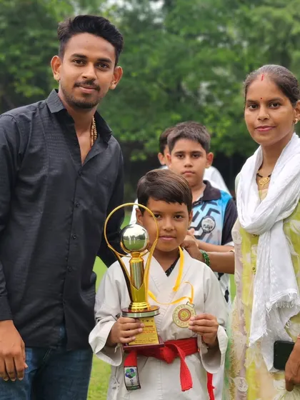 A proud moment with one of my students and his mother after his win at the District Karate Championship. Family support is a huge part of our success.