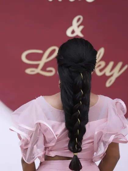 A modern and sleek braid with gold thread woven through it, perfect for a contemporary ethnic look.