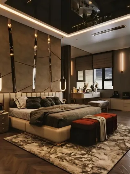 This is an example of a luxury master bedroom we designed, focusing on creating a lavish and restful retreat. The room features a custom upholstered headboard, dramatic accent lighting, and rich textures to create a truly opulent atmosphere with a dedicated seating and vanity area.