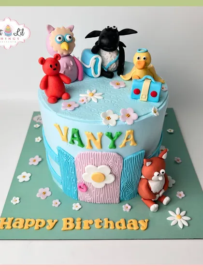 A charming cake featuring characters from the show "Timmy Time." With Shaun the Sheep, an owl, and a teddy bear, it's a delightful cake for a young child's birthday.