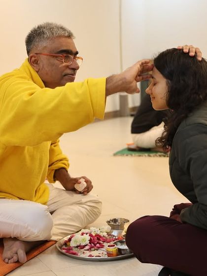 A moment of blessing during the initiation ceremony. This ritual establishes a deep connection between the teacher and the student.