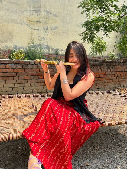 A playful shot from a village, eating sugarcane. This is an authentic and rustic travel moment.