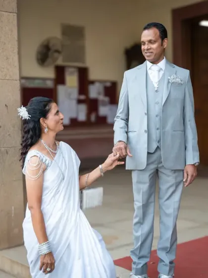 A sweet, chivalrous moment as the husband takes his wife's hand after they renewed their vows for their 25th anniversary. Some things never go out of style.