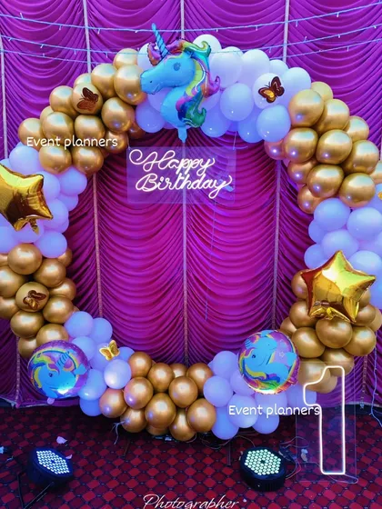 Another angle of the gold and white unicorn-themed birthday decor.