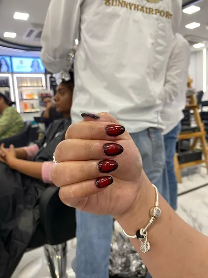 Another angle of the stunning red and black airbrush nails, showcasing the depth and dimension of the design.