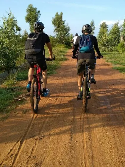 Two riders heading down a dirt path side-by-side. Our rides are about sharing the journey.