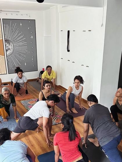 Students engage in a deep lunge during a group class, focusing on alignment and breath. Our studio provides a supportive environment for practitioners of all levels to explore their limits safely.