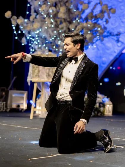A groom's dramatic pose during a couple's performance. We make sure both partners have their moment to shine.