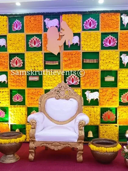 A unique checkerboard backdrop for a baby shower, featuring marigolds, lotus motifs, and sacred cow cutouts. This design is inspired by traditional art and adds a deeply cultural and artistic element to the event.