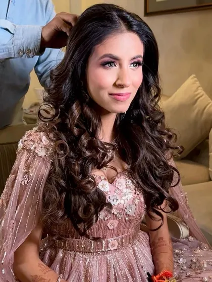 Looking like a real-life princess doll for her engagement. This look features soft pink tones, voluminous curls, and a radiant complexion for a dreamy, romantic feel.