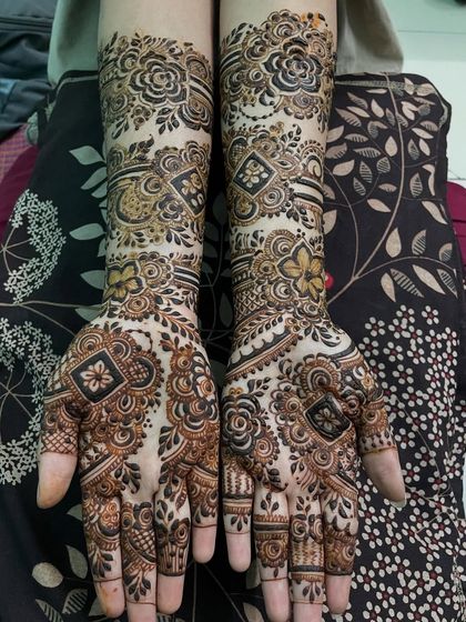 This full-arm design combines geometric shapes with floral patterns. The contrast between the bold, dark flowers and the delicate line work creates a balanced and eye-catching bridal style.