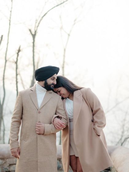 A sweet and tender moment with the beautiful, bare trees of Kashmir creating a serene and romantic backdrop.