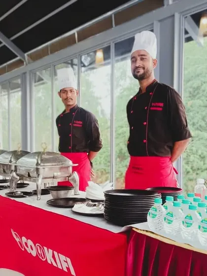A bright and welcoming buffet setup for a house party. Our smiling staff, clean presentation, and branded setup reflect our commitment to professional and reliable catering services.
