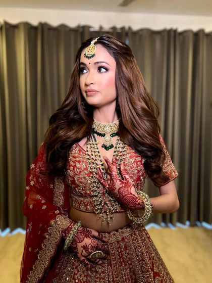 A graceful pose showing off the complete look. The makeup, hair, and outfit all work together in perfect harmony.