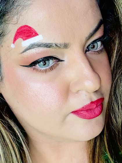 A close-up of my Christmas makeup look. Why wear a hat when you can just draw one on your eyebrow for a fun and unique festive style?