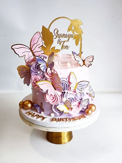 Another gorgeous butterfly cake, this time for Shanaya's 10th birthday. The combination of pink and purple rosettes with gold-accented butterflies is simply magical.