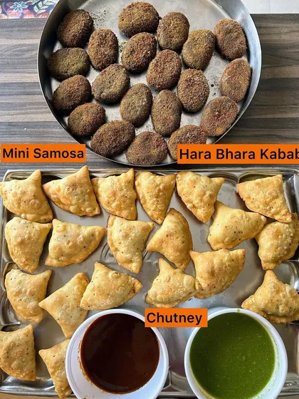 A tray of Mini Samosas and Hara Bhara Kebabs with chutneys.
