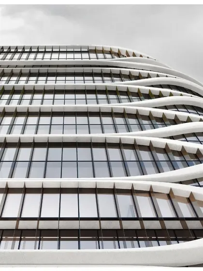 A detail of the undulating balconies of the Hilton Kathmandu, which create a dynamic, wave-like pattern across the facade while providing private outdoor space for guest rooms.