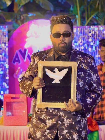 Presenting the magic slate from which a dove picture appears, right before the real one does. It's all about building anticipation.