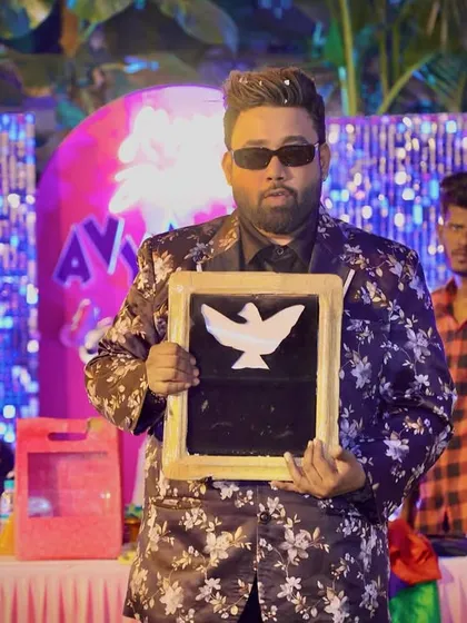 Presenting the magic slate from which a dove picture appears, right before the real one does. It's all about building anticipation.