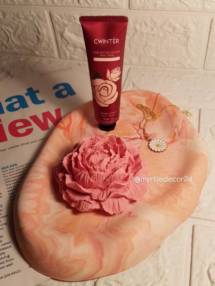 An oval cloud tray in a soft pink and orange marble. We styled it here with a matching Peony diffuser and daily essentials like hand cream.