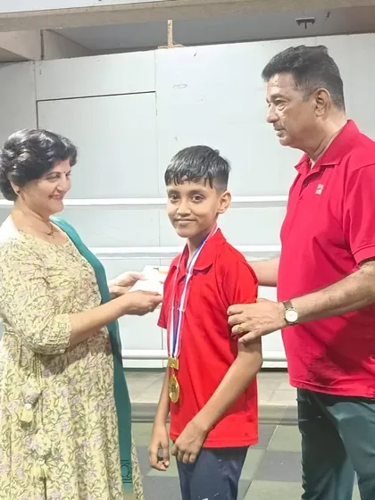 A young gold medalist receiving his award. We are building the next generation of champions.