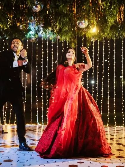 An energetic moment from a couple's performance under the disco balls. The lighting and decor add so much to the vibe of the dance.