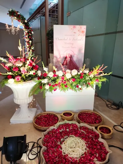 A traditional welcome setup with bowls of fresh flower petals for guests to shower the couple with blessings.