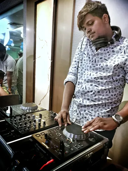 In the zone. For me, DJing is all about focus and feeling the music. This is me concentrating on the mix, making sure every transition is perfect to maintain the flow and energy of the party.