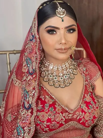 Another angle of this gorgeous red rental lehenga, showing the detailed peacock embroidery on the blouse. Our collection ensures you look stunning from every view on your wedding day.