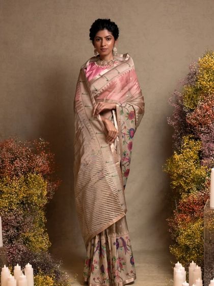 An antique gold organza tissue saree with a traditional Paithani border, a luxurious and lightweight option for receptions.
