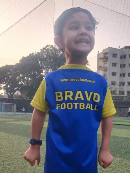 Some of our coaches have this effect on children. A player wears his jersey backward for fun.