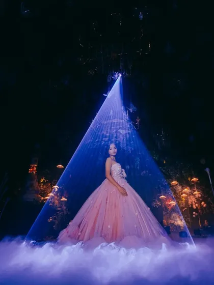 For a truly cinematic effect, I combine a low fog machine with laser light projections. This creates a 'dancing on clouds' illusion, perfect for a couple's first dance at a wedding reception or a magical entry at a milestone birthday party.