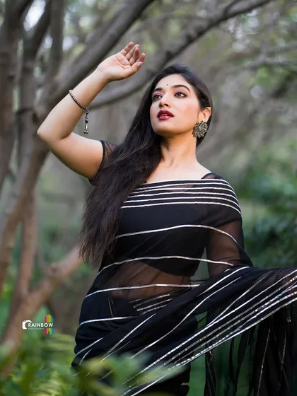 A dramatic pose from the same shoot, where Priyanka Thimmesh is looking up, creating a sense of wonder and elegance.